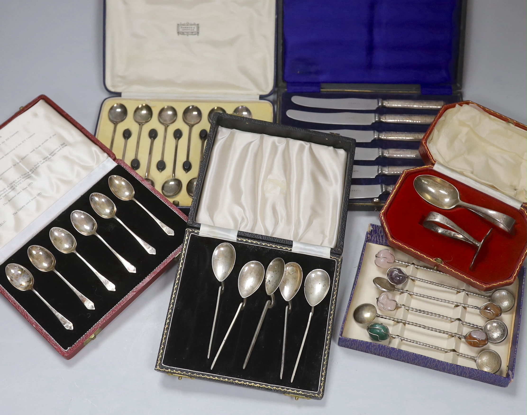Six assorted cased sets of flatware including bean end coffee spoon, preserve spoons and spoon and pusher.